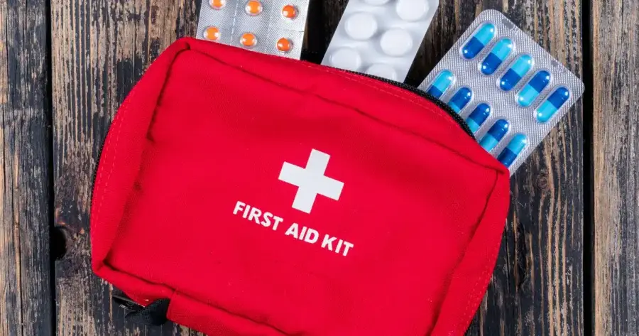 Family reviewing emergency preparedness plan together at kitchen table with supplies
